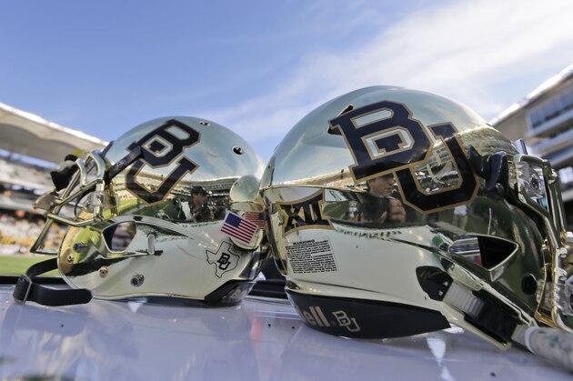FILE - In this Dec. 5, 2015, file photo, Baylor helmets on shown the field after an NCAA college football game in Waco, Texas. For more than a year, the federal civil lawsuits against Baylor have piled in and piled on, accusing the nation's largest Baptist school of mishandling, ignoring or stifling claims of sexual and physical abuse of students for years. After months of bad publicity, the firing of a popular football coach and demotion and departure of a school president, Baylor is starting to make those cases go away with settlements as evidence gathering is just heating up and well before any of them approach trial. (AP Photo/LM Otero, File)