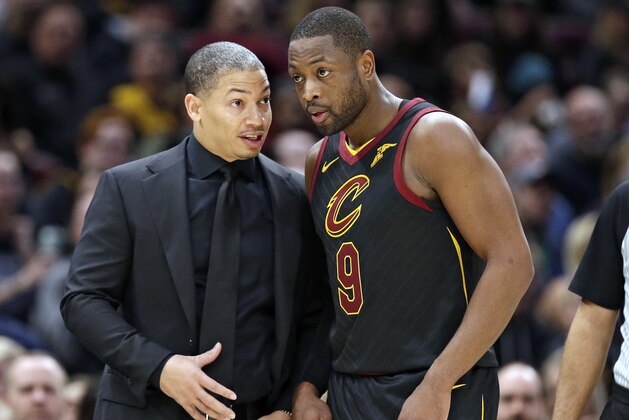 Cleveland Cavaliers head coach Tyronn Lue, left, talks with Dwyane Wade in the second half of an NBA basketball game against the Charlotte Hornets, Friday, Nov. 24, 2017, in Cleveland. (AP Photo/Tony Dejak)