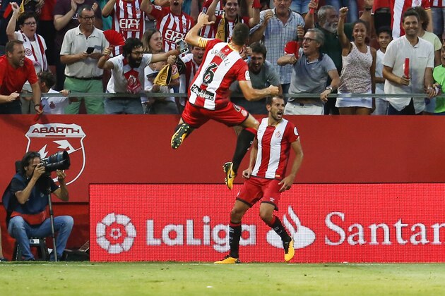 Girona's Uruguayan Cristhian Stuani (R) celebrates with Girona's midfielder Alex Granell after scoring during the Spanish league football match Girona FC vs Club Atletico de Madrid at the Municipal de Montilivi stadium in Girona on August 19, 2017. / AFP PHOTO / PAU BARRENA        (Photo credit should read PAU BARRENA/AFP/Getty Images)