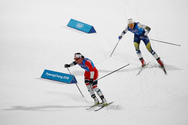 Norway's Marit Bjorgen (L) leads ahead of Sweden's Stina Nilsson during the women's 4x5km classic free style cross country relay at the Alpensia cross country ski centre during the Pyeongchang 2018 Winter Olympic Games on February 17, 2018 in Pyeongchang.  / AFP PHOTO / Odd ANDERSEN        (Photo credit should read ODD ANDERSEN/AFP/Getty Images)