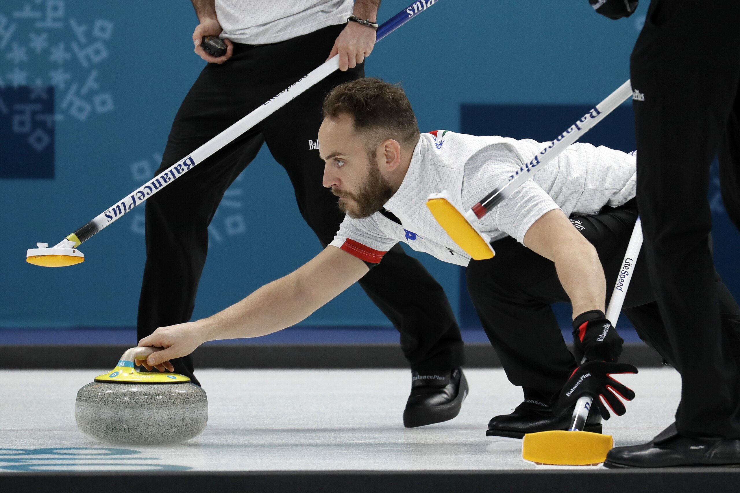 Italy's skip Joel Retornaz prepares to launch the stone during their men's curling match against Japan at the 2018 Winter Olympics in Gangneung, South Korea, Saturday, Feb. 17, 2018. (AP Photo/Aaron Favila)