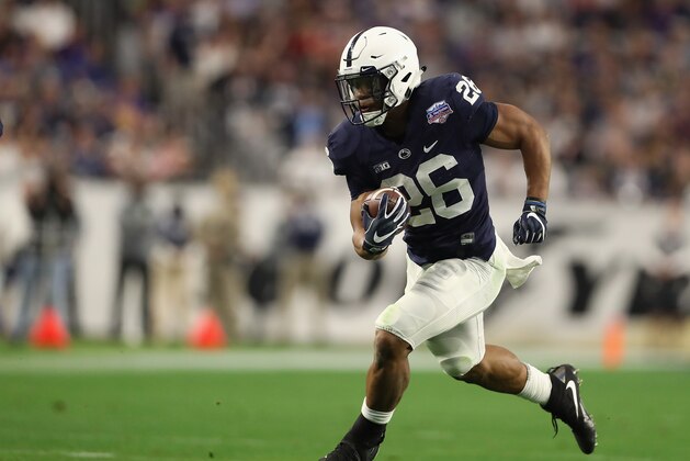 GLENDALE, AZ - DECEMBER 30:  Running back Saquon Barkley #26 of the Penn State Nittany Lions rushes the football against the Washington Huskies during the second half of the Playstation Fiesta Bowl at University of Phoenix Stadium on December 30, 2017 in Glendale, Arizona. The Nittany Lions defeated the Huskies 35-28.  (Photo by Christian Petersen/Getty Images)