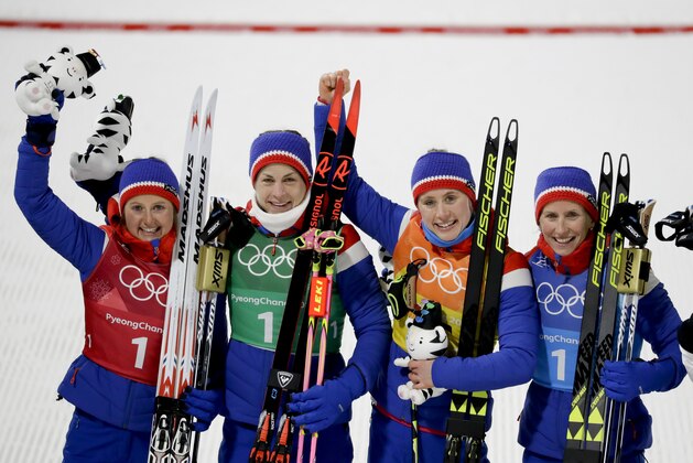 Norway's Ingvild Flugstad Oestberg, from left, Astrid Uhrenholdt Cobsen, Ragnhild Haga and Marit Bjoergen celebrates after winning the the gold medal in the women's 4 x 5km relay cross-country skiing competition at the 2018 Winter Olympics in Pyeongchang, South Korea, Saturday, Feb. 17, 2018. (AP Photo/Kirsty Wigglesworth)