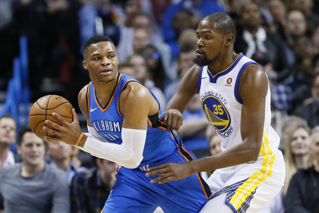 FILE - In this Nov. 22, 2017, file photo, Oklahoma City Thunder guard Russell Westbrook, left, keeps the ball from Golden State Warriors forward Kevin Durant during the first quarter of an NBA basketball game in Oklahoma City. Fans will again get to see games between the former teammates-turned-rivals in 2018. (AP Photo/Sue Ogrocki, File)