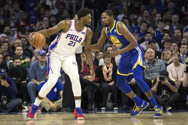 Philadelphia 76ers' Joel Embiid, of Cameroon, left, in action against Golden State Warriors' Kevin Durant, right, during the first half of an NBA basketball game, Saturday, Nov. 18, 2017, in Philadelphia. The Warriors won 124-116. (AP Photo/Chris Szagola)