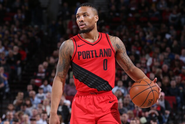 PORTLAND, OR - FEBRUARY 14:  Damian Lillard #0 of the Portland Trail Blazers handles the ball against the Golden State Warriors on February 14, 2018 at the Moda Center Arena in Portland, Oregon. NOTE TO USER: User expressly acknowledges and agrees that, by downloading and or using this photograph, user is consenting to the terms and conditions of the Getty Images License Agreement. Mandatory Copyright Notice: Copyright 2018 NBAE (Photo by Sam Forencich/NBAE via Getty Images)