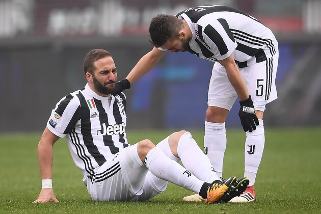 Juventus' forward Gonzalo Higuain from Argentina (L) reacts near Juventus' midfielder Miralem Pjanic of Bosnia-Herzegovina during the Italian Serie A football match between Torino and Juventus at Stadio Grande Torino in Turin on February 18, 2018. / AFP PHOTO / MARCO BERTORELLO        (Photo credit should read MARCO BERTORELLO/AFP/Getty Images)