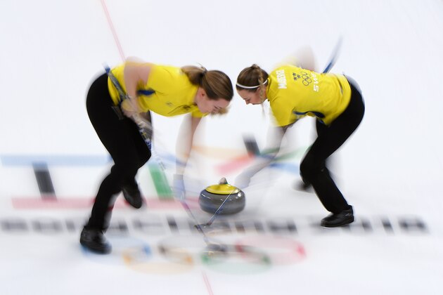 Sweden's Sofia Mabergs (R) brushes in front of the stone during the curling women's round robin session between Britain and Sweden during the Pyeongchang 2018 Winter Olympic Games at the Gangneung Curling Centre in Gangneung on February 18, 2018. / AFP PHOTO / WANG Zhao        (Photo credit should read WANG ZHAO/AFP/Getty Images)