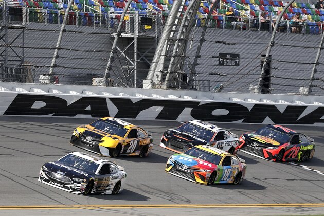 Aric Almirola (10) leads a group of cars through the front stretch, including Erik Jones (20), Kyle Busch (18), Kasey Kahne (95) and Martin Truex Jr. (78) during a practice session for the NASCAR Daytona 500 auto race at Daytona International Speedway, Friday, Feb. 16, 2018, in Daytona Beach, Fla. (AP Photo/John Raoux)