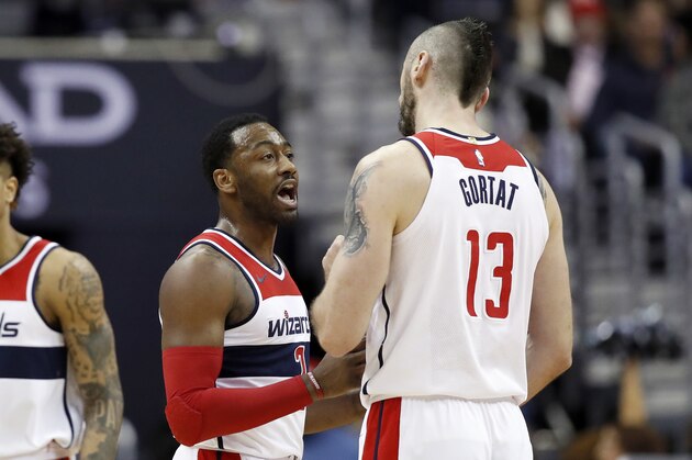 Washington Wizards guard John Wall (2) talks with Washington Wizards center Marcin Gortat (13), from Poland, during the first half of an NBA basketball game Wednesday, Jan. 3, 2018, in Washington. (AP Photo/Alex Brandon)