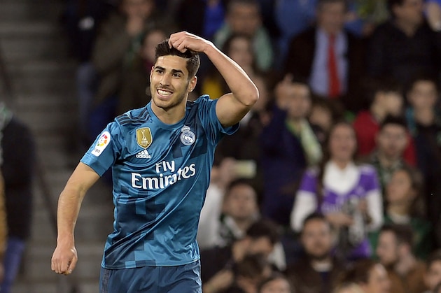 Real Madrid's Spanish midfielder Marco Asensio celebrates scoring a goal during the Spanish league football match Real Betis vs Real Madrid at the Benito Villamarin stadium in Sevilla on February 18, 2018. / AFP PHOTO / Cristina Quicler        (Photo credit should read CRISTINA QUICLER/AFP/Getty Images)