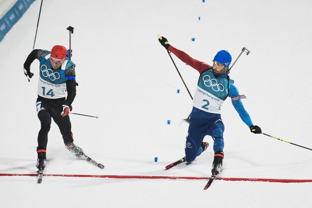 TOPSHOT - France's Martin Fourcade (R) pushes his foot across the finish line to beat Germany's Simon Schempp in the men's 15km mass start biathlon event during the Pyeongchang 2018 Winter Olympic Games on February 18, 2018, in Pyeongchang.
By winning the race Martin Fourcade became Frances most successful Olympian of all. / AFP PHOTO / Odd ANDERSEN        (Photo credit should read ODD ANDERSEN/AFP/Getty Images)