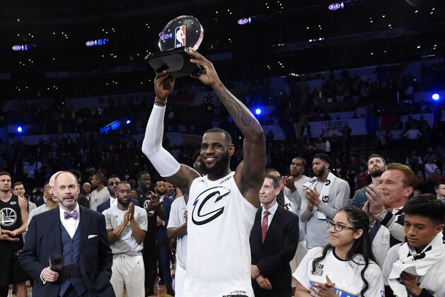 Team LeBron's LeBron James, of the Cleveland Cavaliers, holds the MVP trophy after his team defeated Team Stephen at the NBA All-Star basketball game, Sunday, Feb. 18, 2018, in Los Angeles. Team LeBron won 148-145. (AP Photo/Chris Pizzello)