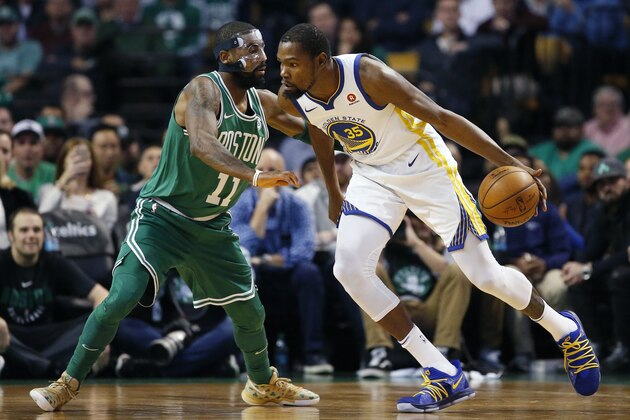 Golden State Warriors' Kevin Durant (35) drives past Boston Celtics' Kyrie Irving (11) during the first quarter of an NBA basketball game in Boston, Thursday, Nov. 16, 2017. (AP Photo/Michael Dwyer)
