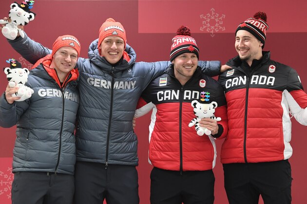 Germany's Francesco Friedrich (L) and Thorsten Margis celebrate next to Canada's Justin Kripps (2nd R) and Alexander Kopacz during the victory ceremony after both team won the gold medal in the 2-man bobsleigh heat 4 final run during the Pyeongchang 2018 Winter Olympic Games, at the Olympic Sliding Centre on February 19, 2018 in Pyeongchang. / AFP PHOTO / Mark RALSTON (Photo credit should read MARK RALSTON/AFP/Getty Images) Germany's Francesco Friedrich (L) and Thorsten Margis celebrate next to Canada's Justin Kripps (2nd R) and Alexander Kopacz during the victory ceremony after both team won the gold medal in the 2-man bobsleigh heat 4 final run during the Pyeongchang 2018 Winter Olympic Games, at the Olympic Sliding Centre on February 19, 2018 in Pyeongchang. / AFP PHOTO / Mark RALSTON (Photo credit should read MARK RALSTON/AFP/Getty Images)