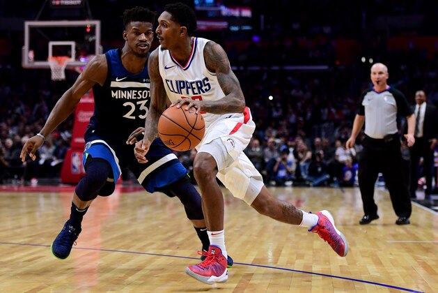 LOS ANGELES, CA - DECEMBER 06:  Lou Williams #23 of the LA Clippers drives to the basket on Jimmy Butler #23 of the Minnesota Timberwolves during a 113-107 Timberwolves win at Staples Center on December 6, 2017 in Los Angeles, California.  (Photo by Harry How/Getty Images)