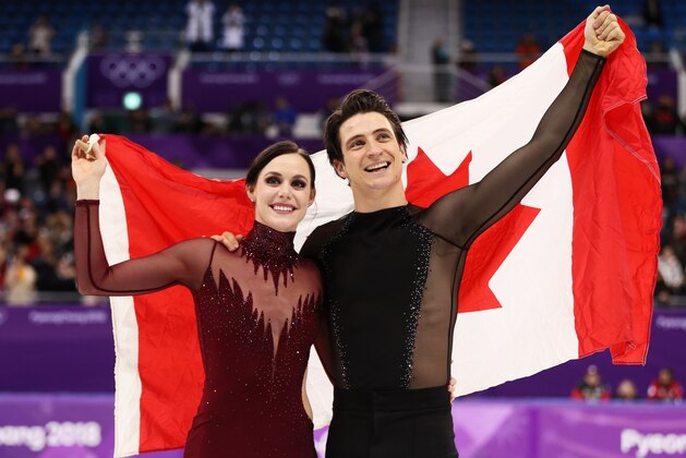 GANGNEUNG, SOUTH KOREA - FEBRUARY 20:  Gold medal winners Tessa Virtue and Scott Moir of Canada celebrate during the victory ceremony for the Figure Skating Ice Dance Free Dance on day eleven of the PyeongChang 2018 Winter Olympic Games at Gangneung Ice Arena on February 20, 2018 in Gangneung, South Korea.  (Photo by Jamie Squire/Getty Images)