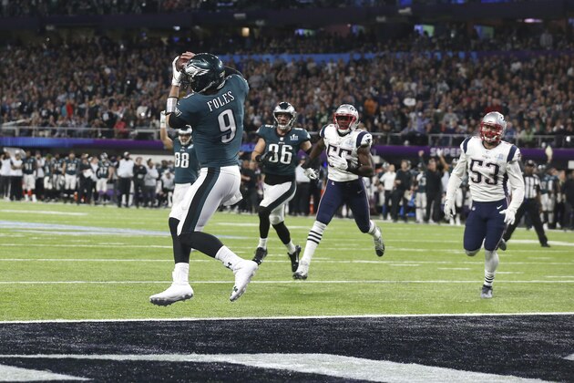 Philadelphia Eagles quarterback Nick Foles (9) catches a touchdown pass from tight end Trey Burton, in the second quarter against the New England Patriots in Super Bowl LII, Sunday, Feb. 4, 2018 in Minneapolis. The Eagles defeated the Patriots 41-33 to win their first Super Bowl. (AP Photo/Doug Benc)