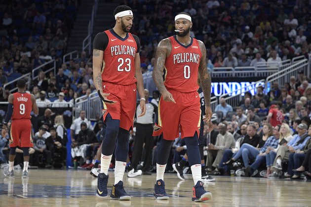 New Orleans Pelicans forward Anthony Davis (23) and center DeMarcus Cousins (0) walk up the court after a play during the first half of an NBA basketball game against the Orlando Magic Friday, Dec. 22, 2017, in Orlando, Fla. (AP Photo/Phelan M. Ebenhack)