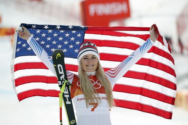 Bronze medal winner Lindsey Vonn, of the United States, celebrates during the flower ceremony for the women's downhill at the 2018 Winter Olympics in Jeongseon, South Korea, Wednesday, Feb. 21, 2018. (AP Photo/Christophe Ena)