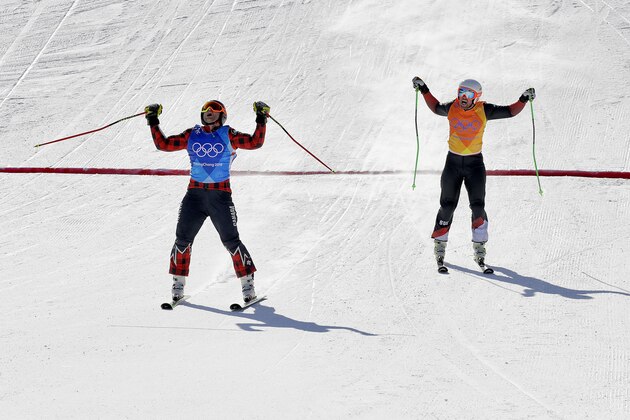 Gold medal winner Brady Leman, of Canada, left, and silver medal winner Marc Bischofberger, of Switzerland, finish the men's ski cross final at Phoenix Snow Park at the 2018 Winter Olympics in Pyeongchang, South Korea, Wednesday, Feb. 21, 2018. (AP Photo/Kin Cheung)