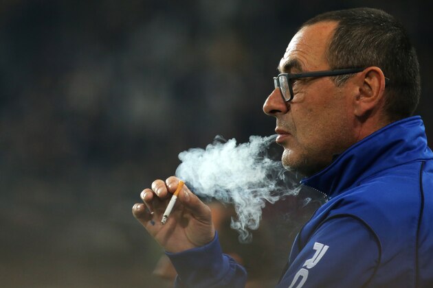 Empoli's coach Maurizio Sarri smokes a cigarette before the Italian Serie A football match Juventus Vs Empoli on April 4, 2015 at the 'Juventus Stadium' in Turin.  AFP PHOTO / MARCO BERTORELLO        (Photo credit should read MARCO BERTORELLO/AFP/Getty Images)