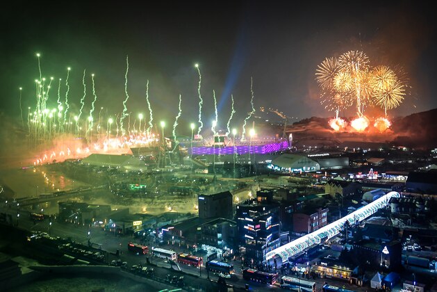 The Olympic Flame is seen from outside as fireworks go off during the opening ceremony of the Pyeongchang 2018 Winter Olympic Games at the Pyeongchang Stadium on February 9, 2018. / AFP PHOTO / Brendan Smialowski        (Photo credit should read BRENDAN SMIALOWSKI/AFP/Getty Images)