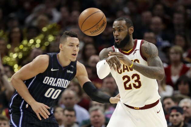 Cleveland Cavaliers' LeBron James (23) passes against Orlando Magic's Aaron Gordon (00) in the second half of an NBA basketball game, Thursday, Jan. 18, 2018, in Cleveland. (AP Photo/Tony Dejak)