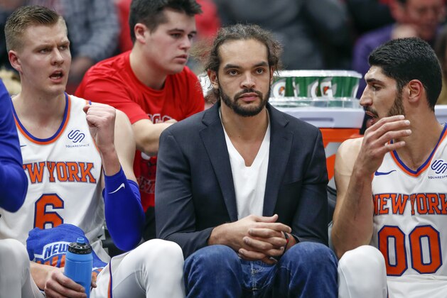 New York Knicks center Joakim Noah, center, sits on the bench between forward Kristaps Porzingis, left, and center Enes Kanter, right, during the first half of an NBA basketball game against the Chicago Bulls, Saturday, Dec. 9, 2017, in Chicago. (AP Photo/Kamil Krzaczynski)