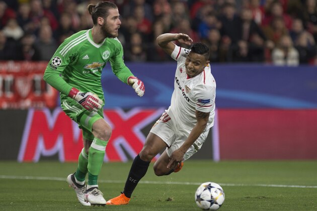 Manchester United's Spanish goalkeeper David De Gea (L) vies with Sevilla's Colombian forward Luis Muriel during the UEFA Champions League round of 16 first leg football match Sevilla FC against Manchester United at the Ramon Sanchez Pizjuan stadium in Sevilla on February 21, 2018. / AFP PHOTO / JORGE GUERRERO        (Photo credit should read JORGE GUERRERO/AFP/Getty Images)