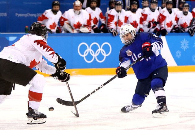 GANGNEUNG, SOUTH KOREA - FEBRUARY 22:  Jocelyne Lamoureux #17 of the United States shoots the puck around Lauriane Rougeau #5 of Canada in overtime during the Women's Gold Medal Game on day thirteen of the PyeongChang 2018 Winter Olympic Games at Gangneung Hockey Centre on February 22, 2018 in Gangneung, South Korea.  (Photo by Jamie Squire/Getty Images)