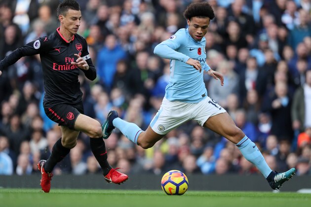 MANCHESTER, ENGLAND - NOVEMBER 05:  Leroy Sane of Manchester City competes with Laurent Koscielny of Arsenal during the Premier League match between Manchester City and Arsenal at Etihad Stadium on November 5, 2017 in Manchester, England.  (Photo by Matthew Ashton - AMA/Getty Images)