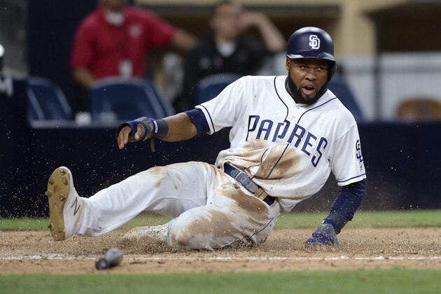 San Diego Padres' Manuel Margot slides into home on a RBI single by Carlos Asuaje during the sixth inning of a baseball game against the Arizona Diamondbacks Tuesday, Sept. 19, 2017, in San Diego. (AP Photo/Orlando Ramirez)