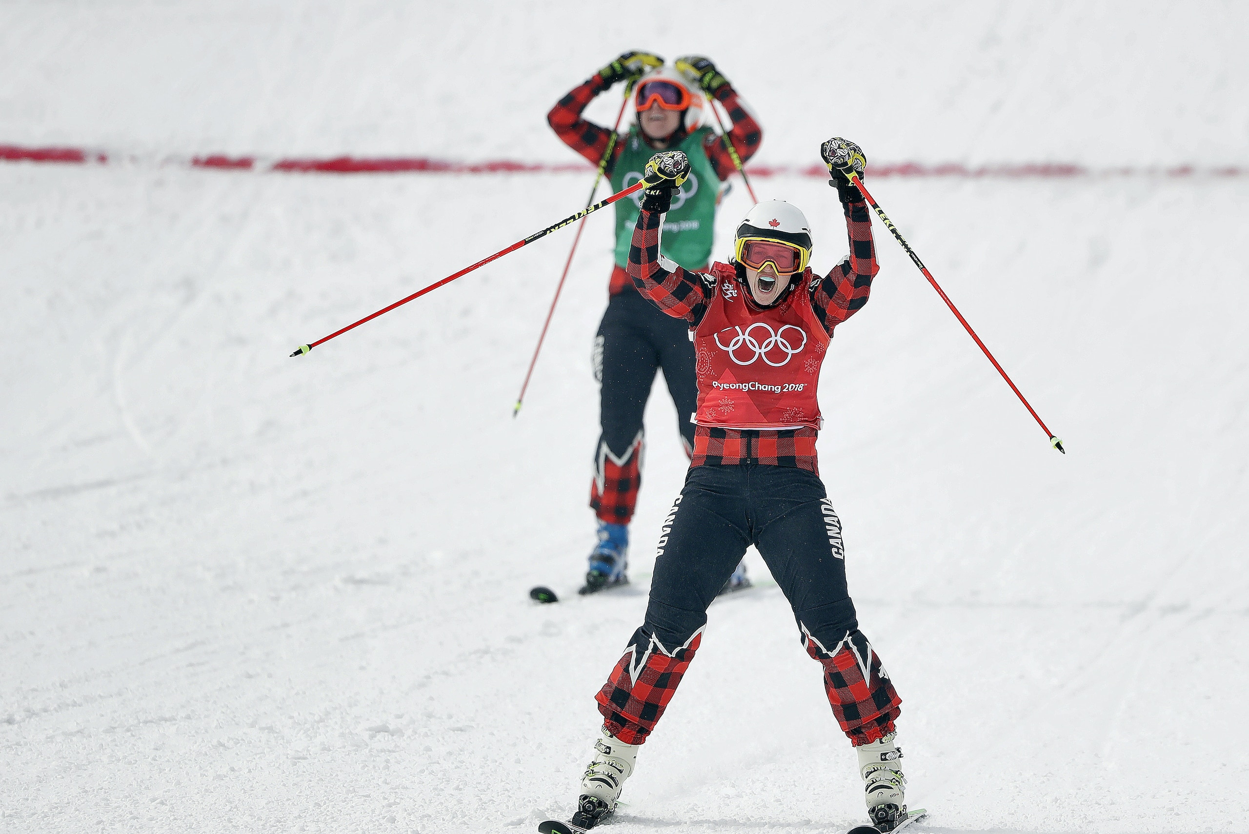 Gold medal winner Kelsey Serwa, of Canada, front, and silver medal winner Brittany Phelan, of Canada, cross the finish line during the women's ski cross final at Phoenix Snow Park at the 2018 Winter Olympics in Pyeongchang, South Korea, Friday, Feb. 23, 2018. (AP Photo/Gregory Bull)