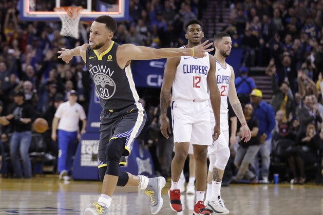 Golden State Warriors' Stephen Curry (30) celebrates after making a 3-point basket at the buzzer in the first quarter of the team's NBA basketball game against the Los Angeles Clippers on Thursday, Feb. 22, 2018, in Oakland, Calif. (AP Photo/Marcio Jose Sanchez)