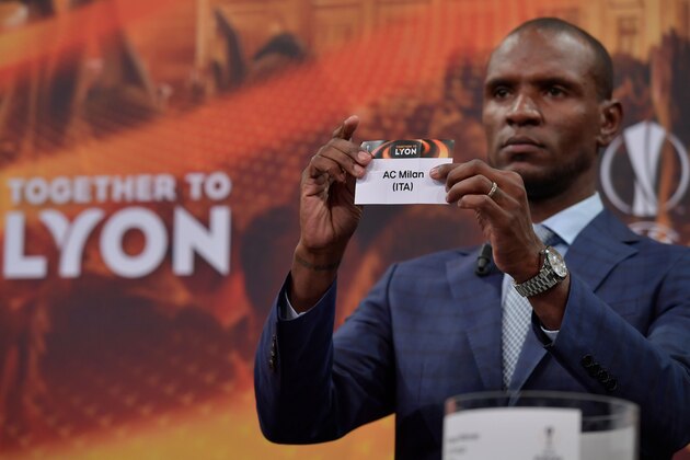 French former international Eric Abidal  shows the slip of AC Milan  during the draw for the round of 32 of the UEFA Europa League football tournament at the UEFA headquarters in Nyon on December 11, 2017. / AFP PHOTO / Fabrice COFFRINI        (Photo credit should read FABRICE COFFRINI/AFP/Getty Images)