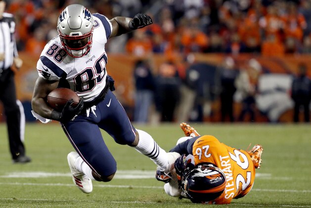 FILE - In this Sunday, Nov. 12, 2017, file photo, New England Patriots tight end Martellus Bennett (88) is tripped up by Denver Broncos free safety Darian Stewart (26) during the first half of an NFL football game in Denver. Bennett is still coming to terms with how his Green Bay tenure ended. But he says being back in familiar surroundings is helping him to deal with it. (AP Photo/Jack Dempsey, File)