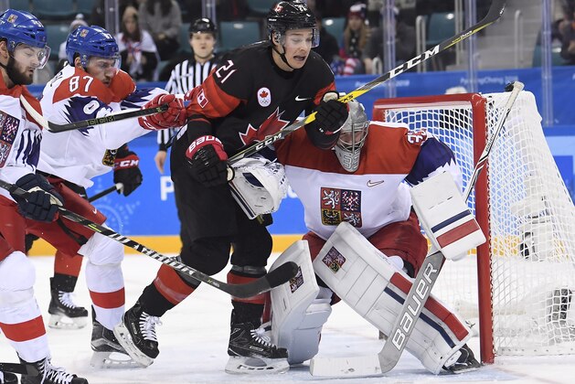Czech Republic goaltender Pavel Francouz (33) makes a save on Canada forward Mason Raymond (21) as Czech Republic defenceman Jakub Nakladal (87) defends during first period preliminary round men's hockey action at the 2018 Olympic Winter Games in Pyeongchang, South Korea, on Saturday, February 17, 2018. (Nathan Denette/The Canadian Press via AP)