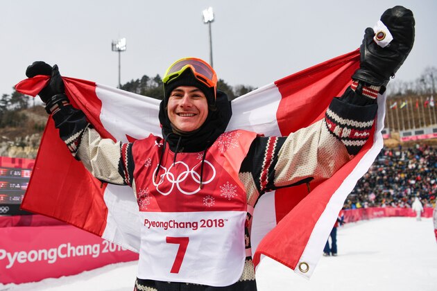 Gold medalist Canada's Sebastien Toutant is draped in the Canadian national flag following the final of the men's snowboard big air event at the Alpensia Ski Jumping Centre during the Pyeongchang 2018 Winter Olympic Games on February 24, 2018 in Pyeongchang.  / AFP PHOTO / Jonathan NACKSTRAND        (Photo credit should read JONATHAN NACKSTRAND/AFP/Getty Images)