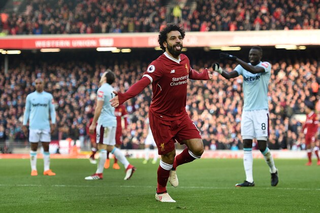 Liverpool's Egyptian midfielder Mohamed Salah celebrates scoring the team's second goal during the English Premier League football match between Liverpool and West Ham United at Anfield in Liverpool, north west England on February 24, 2018. / AFP PHOTO / Oli SCARFF / RESTRICTED TO EDITORIAL USE. No use with unauthorized audio, video, data, fixture lists, club/league logos or 'live' services. Online in-match use limited to 75 images, no video emulation. No use in betting, games or single club/league/player publications.  /         (Photo credit should read OLI SCARFF/AFP/Getty Images)