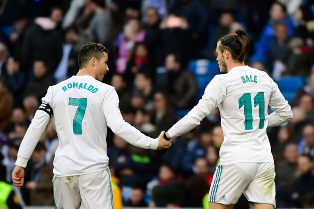 Real Madrid's Welsh forward Gareth Bale (R) celebrates with Real Madrid's Portuguese forward Cristiano Ronaldo after scoring during the Spanish league football match between Real Madrid CF and Deportivo Alaves at the Santiago Bernabeu stadium in Madrid on February 24, 2018. / AFP PHOTO / PIERRE-PHILIPPE MARCOU        (Photo credit should read PIERRE-PHILIPPE MARCOU/AFP/Getty Images)