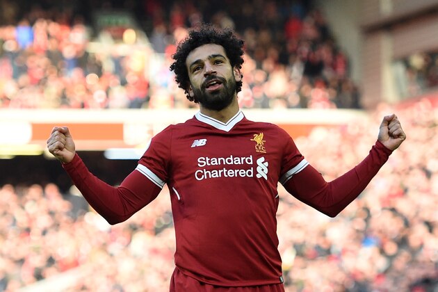 Liverpool's Egyptian midfielder Mohamed Salah celebrates scoring the team's second goal during the English Premier League football match between Liverpool and West Ham United at Anfield in Liverpool, north west England on February 24, 2018. / AFP PHOTO / Oli SCARFF / RESTRICTED TO EDITORIAL USE. No use with unauthorized audio, video, data, fixture lists, club/league logos or 'live' services. Online in-match use limited to 75 images, no video emulation. No use in betting, games or single club/league/player publications.  /         (Photo credit should read OLI SCARFF/AFP/Getty Images)