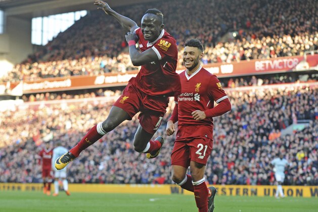 Liverpool's Sadio Mane, left, celebrates scoring his sides fourth goal during the English Premier League soccer match between Liverpool and West Ham United at Anfield in Liverpool, England, Saturday, Feb. 24, 2018. (AP Photo/Rui Vieira)