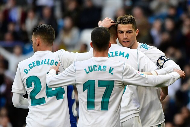 Real Madrid's French forward Karim Benzema (2R) celebrates with    Real Madrid's Spanish midfielder Daniel Ceballos (L), Real Madrid's Spanish midfielder Lucas Vazquez (C) and Real Madrid's Portuguese forward Cristiano Ronaldo (R) after scoring during the Spanish league football match between Real Madrid CF and Deportivo Alaves at the Santiago Bernabeu stadium in Madrid on February 24, 2018. / AFP PHOTO / PIERRE-PHILIPPE MARCOU        (Photo credit should read PIERRE-PHILIPPE MARCOU/AFP/Getty Images)