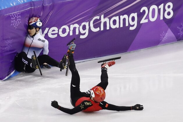 Seo Yira of South Korea and Han Tianyu of China crash during their men's 500 meters short track speedskating quarterfinal in the Gangneung Ice Arena at the 2018 Winter Olympics in Gangneung, South Korea, Thursday, Feb. 22, 2018. (AP Photo/Morry Gash)