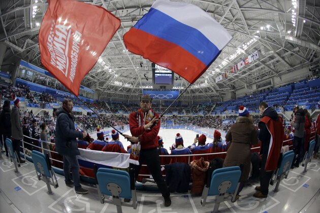 A fan of Russian athletes waves flags before the preliminary round of the men's hockey game between the team from Russia and the United States at the 2018 Winter Olympics in Gangneung, South Korea, Saturday, Feb. 17, 2018. (AP Photo/Julio Cortez, File)