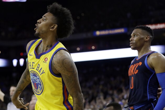 Golden State Warriors' Nick Young, left, follows through on a 3-point basket next to Oklahoma City Thunder's Russell Westbrook during the second half of an NBA basketball game Saturday, Feb. 24, 2018, in Oakland, Calif. (AP Photo/Marcio Jose Sanchez)