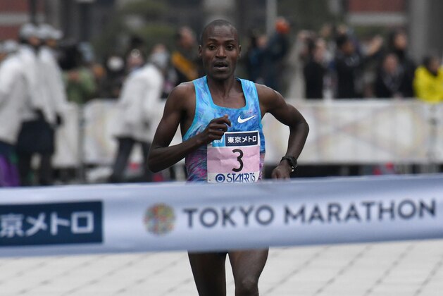 Dickson Chumba of Kenya crosses the finish line to win the Tokyo Marathon in Tokyo on February 25, 2018. / AFP PHOTO / Toru YAMANAKA        (Photo credit should read TORU YAMANAKA/AFP/Getty Images)