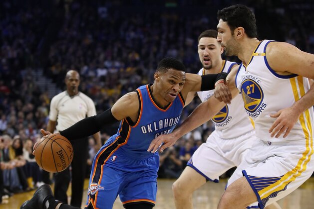 OAKLAND, CA - JANUARY 18:  Russell Westbrook #0 of the Oklahoma City Thunder drives on Zaza Pachulia #27 and Klay Thompson #11 of the Golden State Warriors at ORACLE Arena on January 18, 2017 in Oakland, California.  NOTE TO USER: User expressly acknowledges and agrees that, by downloading and or using this photograph, User is consenting to the terms and conditions of the Getty Images License Agreement.  (Photo by Ezra Shaw/Getty Images)