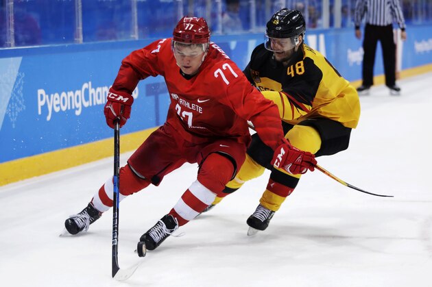 Russian athlete Kirill Kaprizov (77) tries to keep Frank Hordler (48), of Germany, away from the puck during the second period of the men's gold medal hockey game at the 2018 Winter Olympics, Sunday, Feb. 25, 2018, in Gangneung, South Korea. (AP Photo/Julio Cortez)